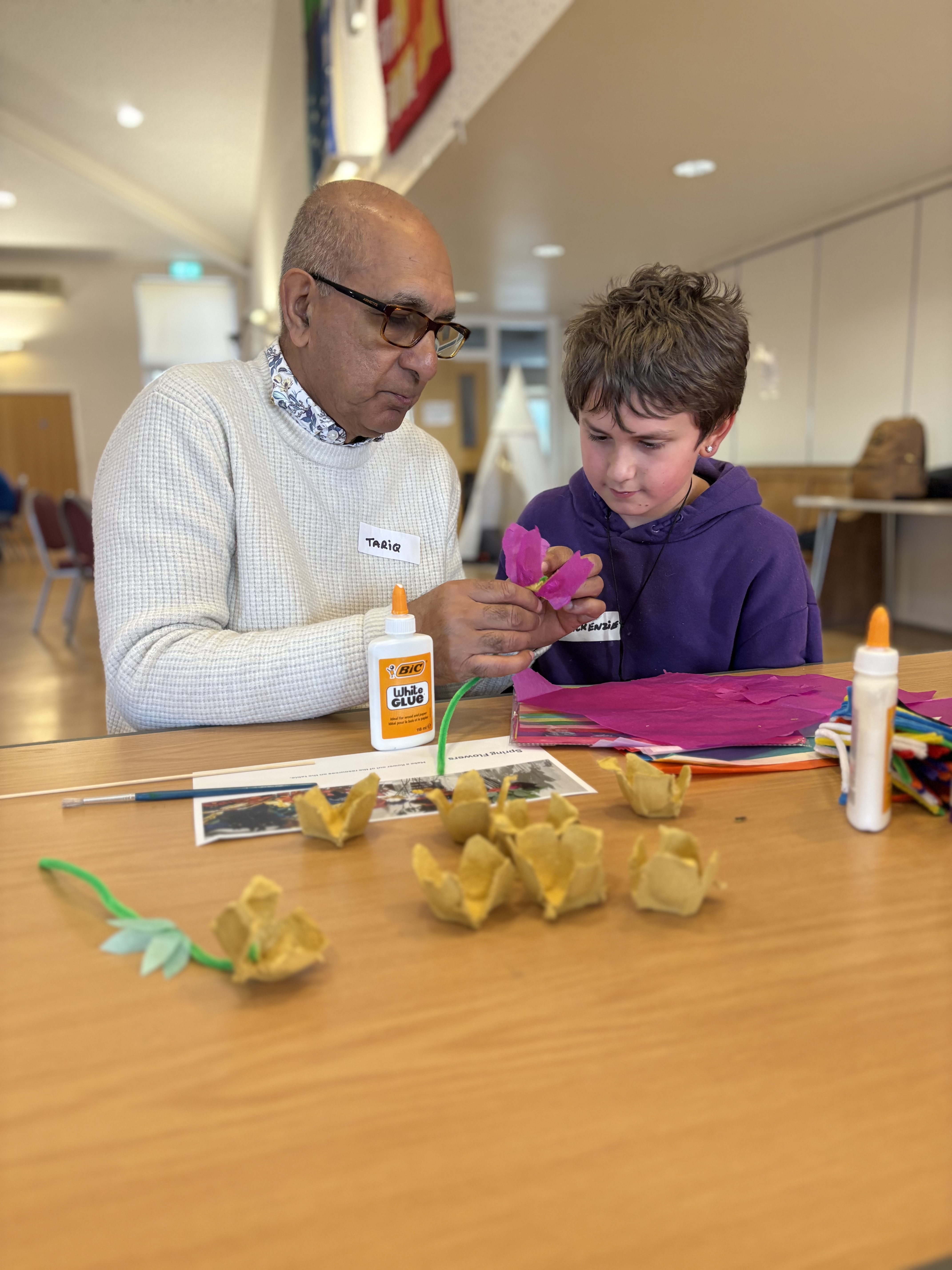 All In participant and helper making a flower craft