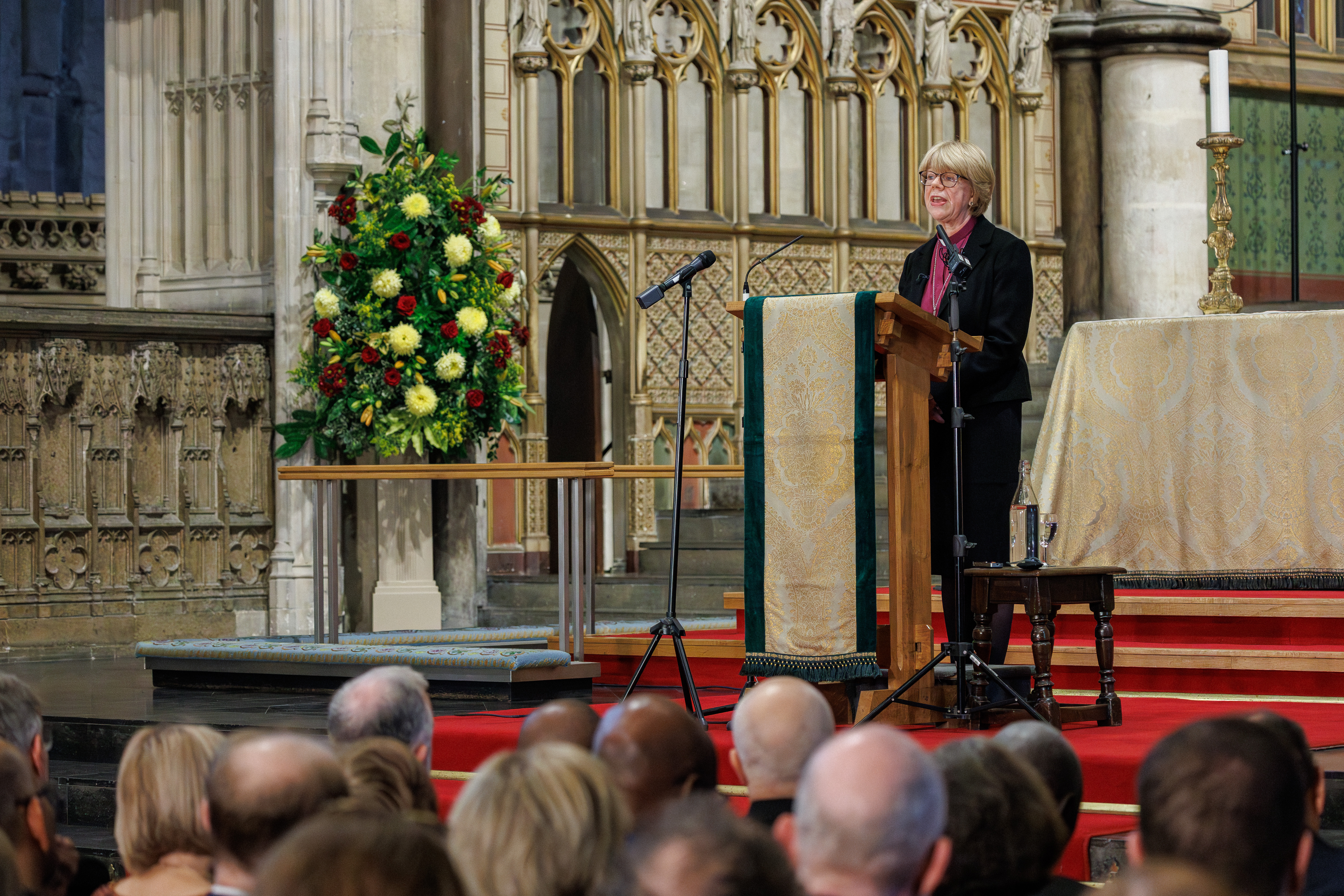 Bishop Sarah at a lecturn in the quire at Canterbury Cathedral
