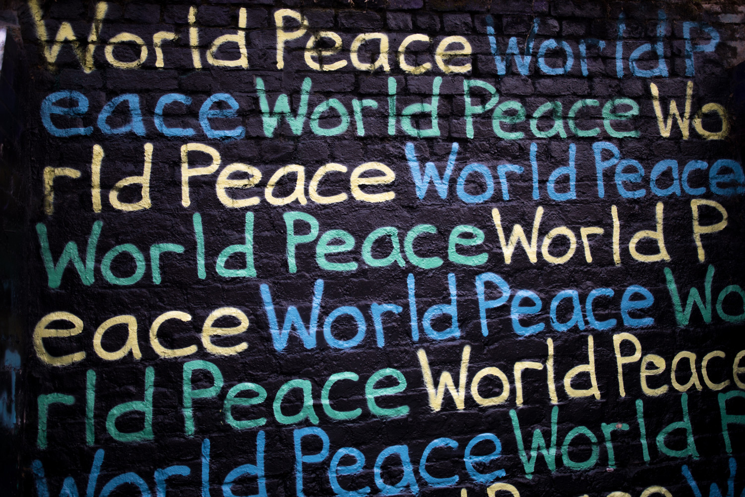 Wall with 'world peace' written in a repeating pattern