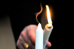 Image of a candle lighting another candle