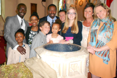 Image of a group of people gathered around a font